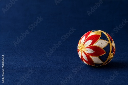 Traditional Japanese temari ball on deep blue background with copy space