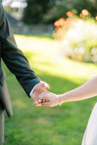 Photography Romantic couple holding hands in Toronto garden
