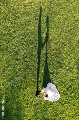 Aerial View of Bride and Groom Holding Hands on Green Lawn at Erin Estate