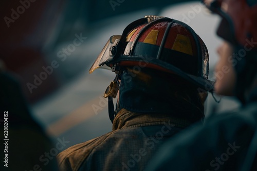 firefighter in helmet observing emergency scene
