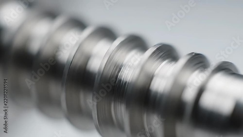 Metal Screw Rotating Smoothly in a Close-Up Macro Shot, Showcasing Industrial Precision and Mechanical Engineering.