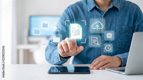 Person interacting with a digital document hologram on a screen at an office desk with data processing float air around central document icon Various icons representing file management cloud storage