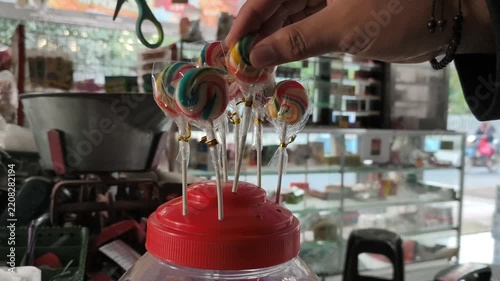 Arranging Colorful Lollipops for Sale at Market Stall