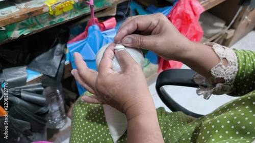 Hands Handling a Small Plastic Bag at Local Market