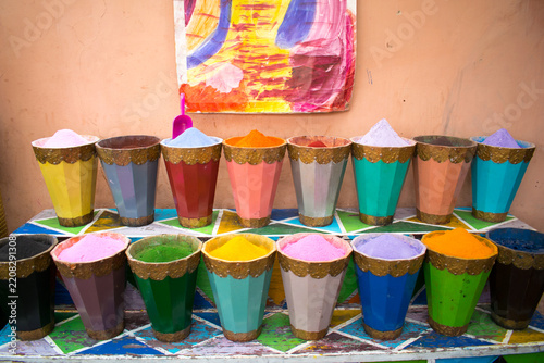 Rows of colorful pigment powder cones displayed at a Moroccan market stall