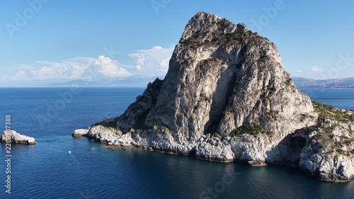 Aerial drone view of Cape Zafferano in Sicily, Italy, showing rugged rocky coastline of the Tyrrhenian Sea with crystal clear turquoise water, small islands and beautiful Mediterranean landscape.