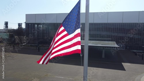 American flag waving on a flagpole against blue sky