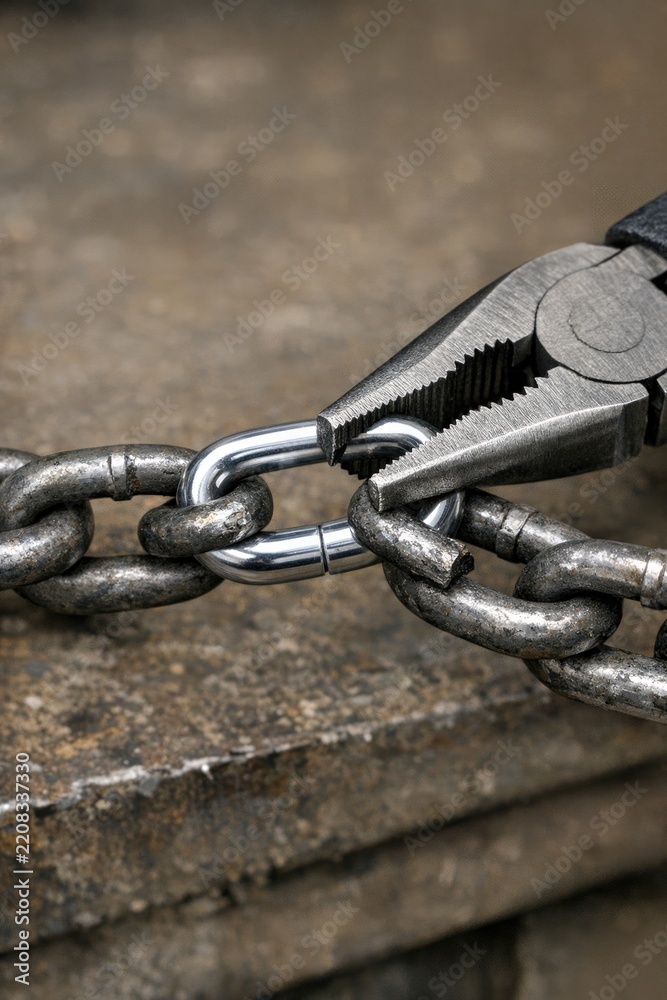 Fototapeta premium A pair of pliers attached to a chain, useful for industrial or construction scene
