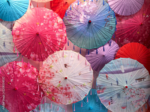 Colorful paper umbrellas create a stunning display in a vibrant setting