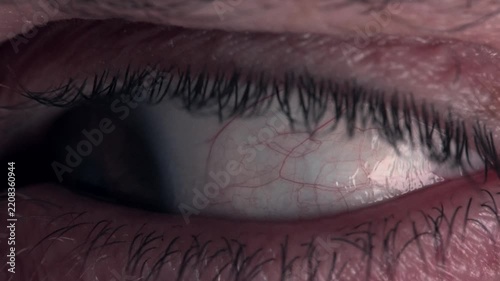A close up shot of a human eyeball at night
