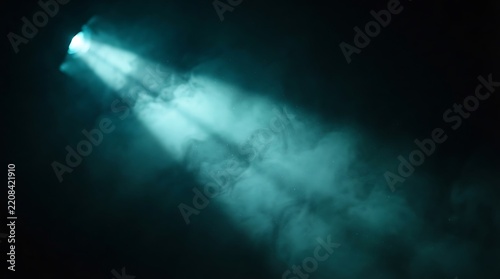 Turquoise light beam illuminating smoke in darkness, abstract atmospheric background for creative design projects