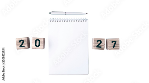 2027 desk calendar concept, minimalist white calendar with wooden year numbers, New Year planning and future date concept for business, office and lifestyle design