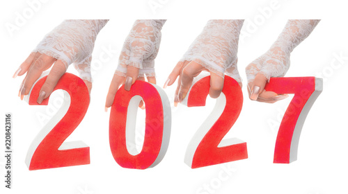 Dynamic 2027 New Year typography, red and white layered numbers held by hands, creative celebration concept for countdown, goals, annual change and future success