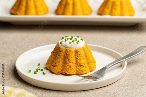 Pumpkin flan on a plate, northern Italian sformatino made with butternut squash puree, ricotta, eggs and parmesan cheese, baked in ramekin.