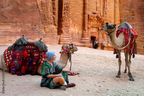 Woman Sitting with Camels in Petra Desert