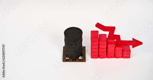Obraz na plátně Oil barrel beside a descending block chart and downward arrow symbolizing falling petroleum prices isolated on white background