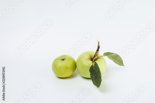 Two fresh green apples on white background