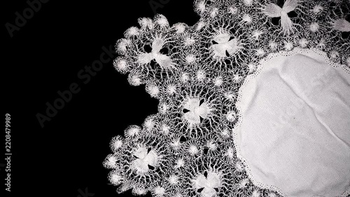 Tenerife lace, needle lace antique traditional doily also known as Spanish Sol Lace embroidery, whitework, white work, needlework. Isolated on black background, border art design, top view, vintage. 