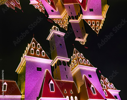 Abstract night view of a surreal mirrored illuminated fairy tale castle architecture