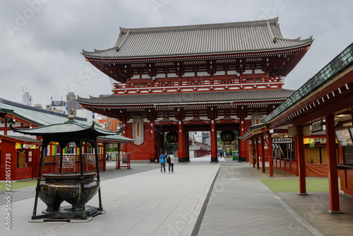 A man walks past a large incense burner in the courtyard of the historic Senso-ji temple in Asakusa, Taito, Tokyo, Japan during his visit.