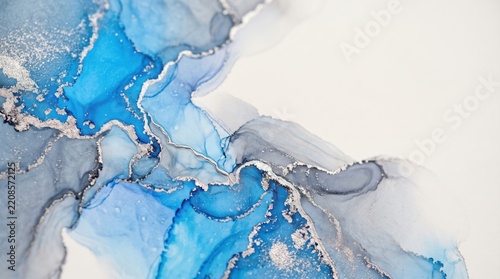 Abstract alcohol ink painting with flowing blue and grey pigment washes accented by metallic silver veins on a white background