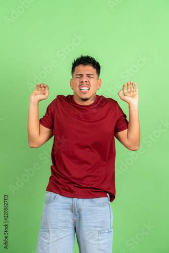 Obraz na plátně Young adult man expressing disgust, repulsion or disappointment
