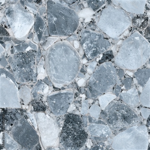 Close view of irregular gray stone paving with pale mortar joints, showing natural speckles, rough texture, and varied rock shapes.