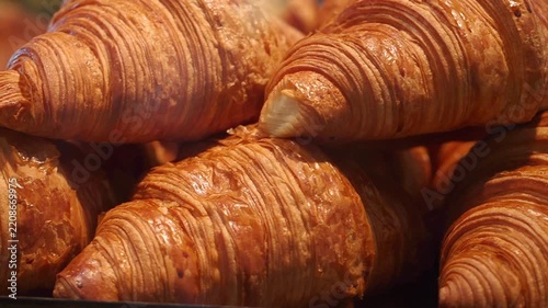 A delightful array of fresh croissants beautifully displayed in a bakery shop