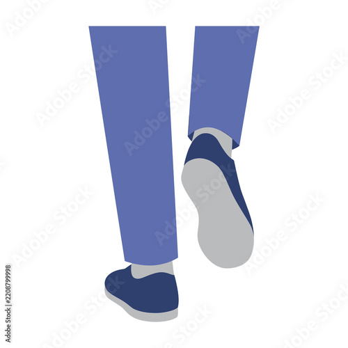 Legs and feet of a person walking forward wearing blue trousers and casual shoes