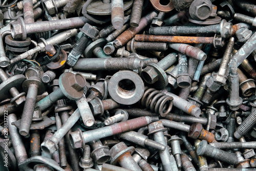 Rusty metal bolts and screws creating industrial background