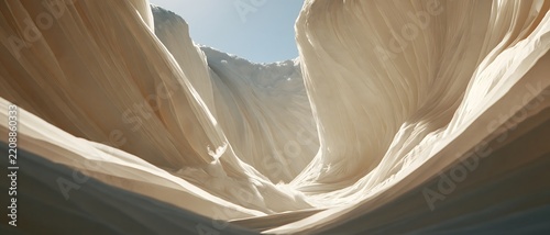 Sandstone canyon formation with sweeping sculpted walls, warm sunlight, and dramatic natural texture surrounding narrow desert passage
