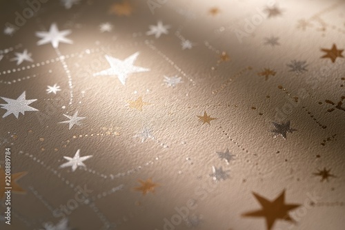 Closeup of elegant gold and silver star pattern on textured paper background, festive celestial design for holiday stationery and gift wrapping