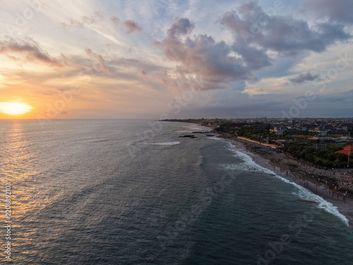 Scenic sunset over the ocean and coastline with dramatic clouds