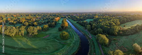 Aerial Panorama of River Mersey, Didsbury Golf Course and Manchester Skyline at Sunrise. 