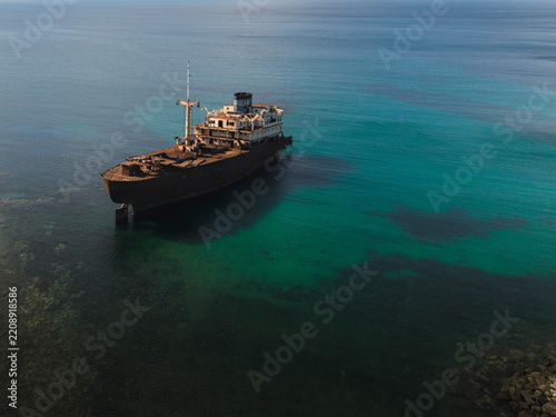 Rusty shipwreck Temple Hall rests in the tranquil sea of Lanzarote