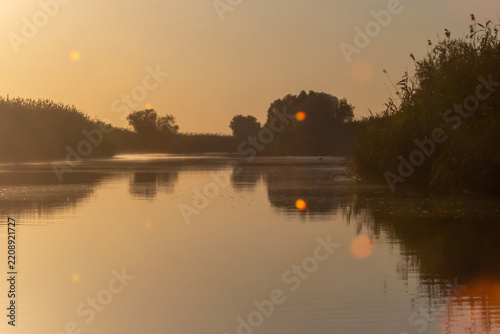 Russia. Astrakhan region. Volga River Delta. River morning with mist and sun light