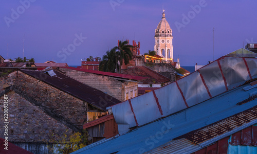 Church tower over rooftops at twilight in Casco Viejo