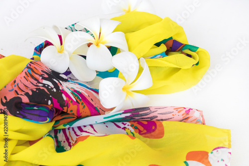 white flowers frangipani with yellow scarf of lifestyle woman relax arrangement flat lay style on background white 