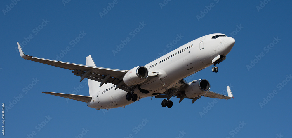 Fototapeta premium The plane lands, passenger airliner. The plane lands. Airplane, passengers flying in the blue sky, preparing to land at the airport