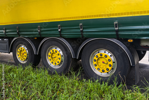 Truck parked by the roadside with visible wheels and tires