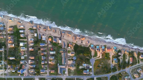 Top-down aerial view of coastal erosion affecting oceanfront houses in Buxton on Hatteras Island in the Outer Banks of North Carolina, United States
