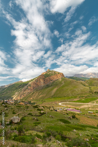 The grassy slopes and rocky summits of the Caucasus Mountains in Chegem Gorge