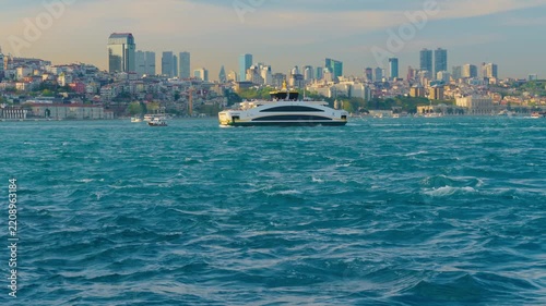 Modern Passenger Ferry Boat Cruising on the Bosphorus Strait in Istanbul with Urban City Skyline Background