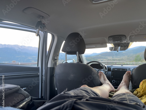 Person relaxing in car looking at mountains of Catalonia