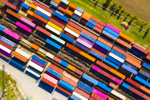  Aerial view of containers at railway. Big container terminal on a railroad with open storage area.