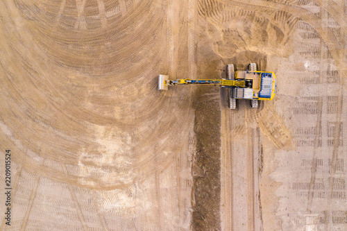 Excavator on a construction site. Aerial view from european industry.