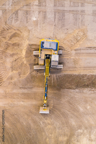 Excavator on a construction site. Aerial view from european industry.
