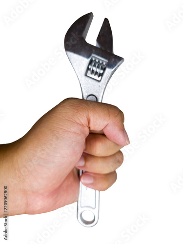 Hand holding a steel adjustable wrench on a white surface
