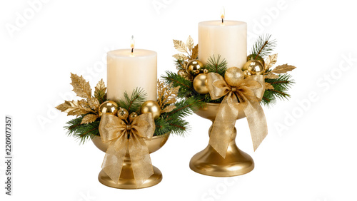 Elegant gold Christmas candle arrangement with two white pillar candles pine greenery golden ornaments bows festive centerpiece isolated on white background