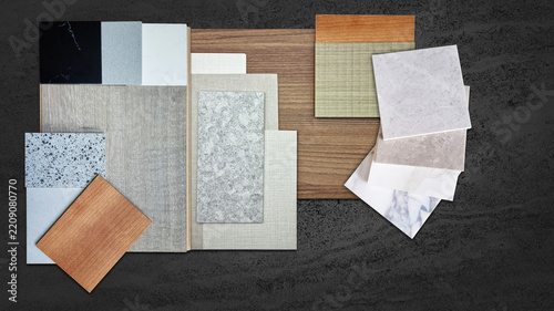 Interior design material samples flat lay mood board featuring wood veneer marble granite stone terrazzo tile fabric swatches for architectural decor home renovation project presentation background.